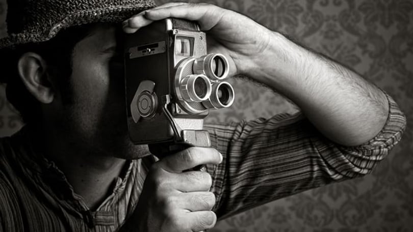 a filmaker with vintage camera